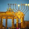 huge outdoor menorah in front of an arch