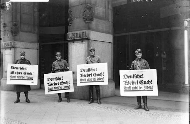 Members of the SA picket in front of a Jewish place of business during the Nazi boycott of Jewish businesses, 1 April 1933. (German National Archives/Wikimedia Commons)