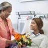 Mother bringing daughter flowers in hospital