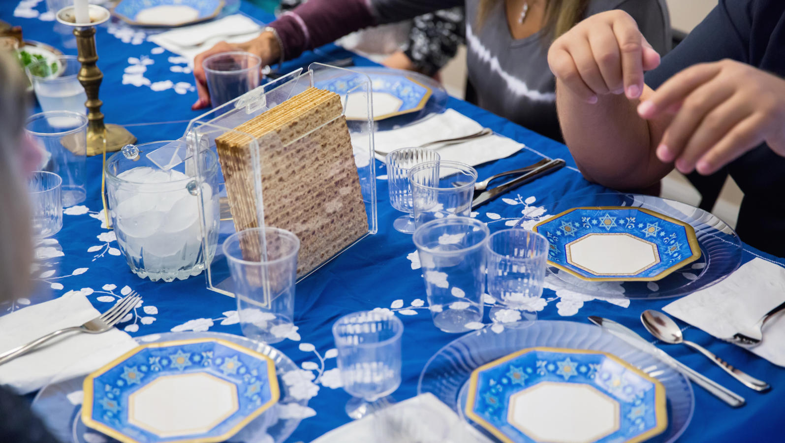A traditional Passover seder table, featuring matzah, glasses of wine, and other traditional Passover foods.