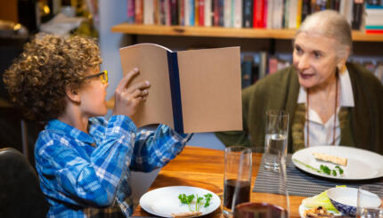 Little Boy Pointing to the Haggadah at Passover Seder