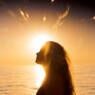 Woman silhouetted at sunset.