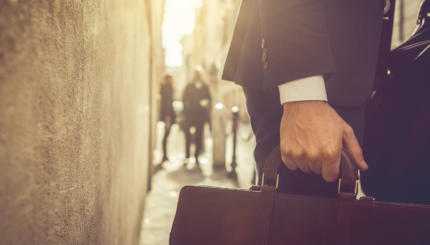 Business person walking with briefcase