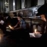 Ultra-Orthodox Jewish men use a candle l