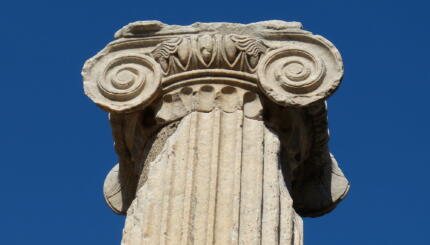top of an ancient column against a blue sky