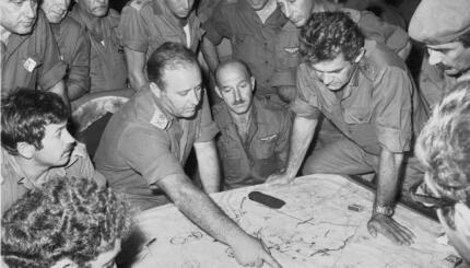 black and white photo of soldiers consulting a map