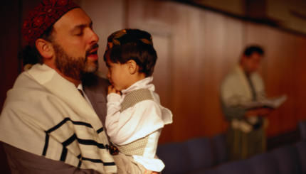 Jewish Man Holding Son and Praying