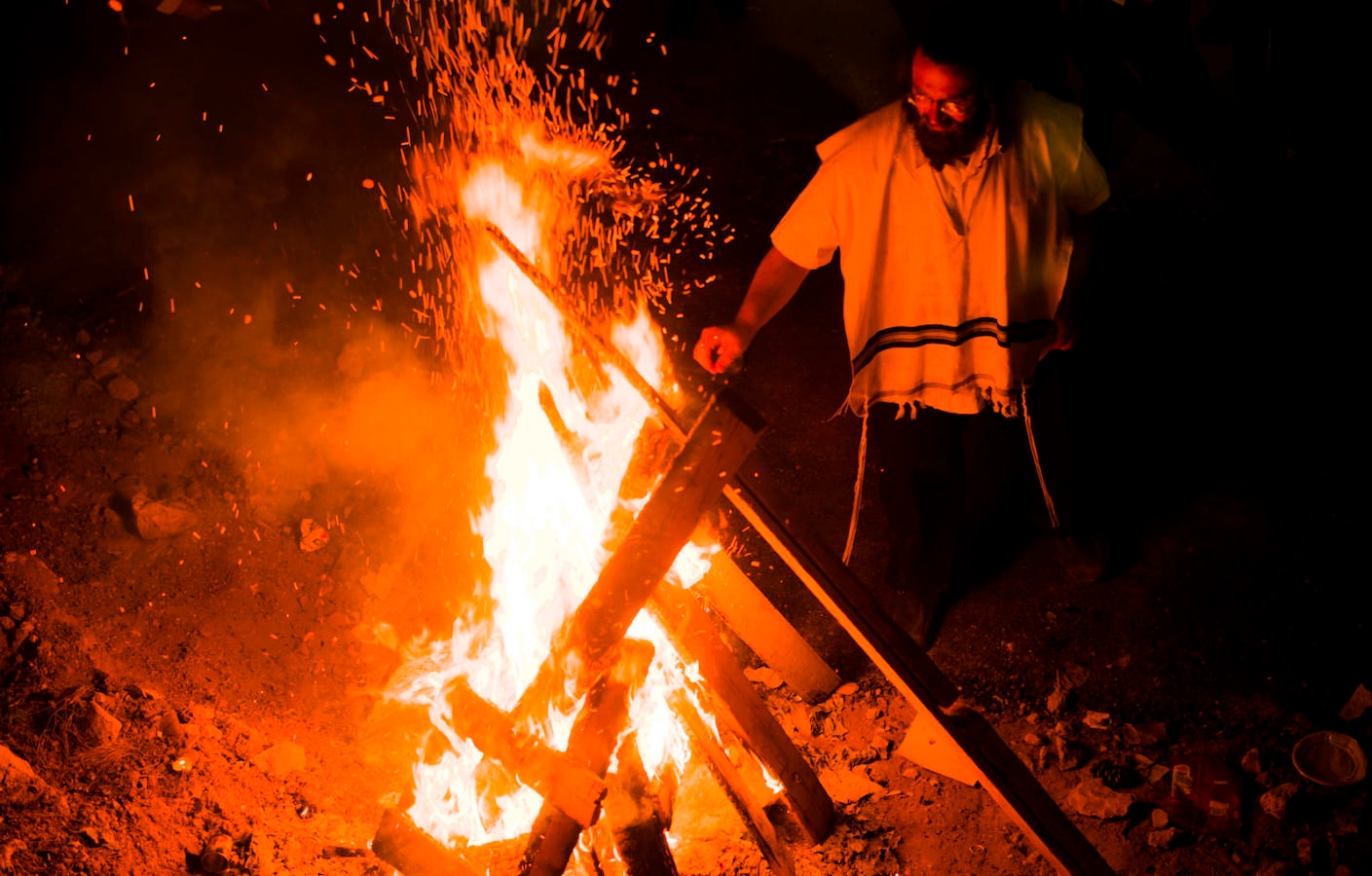 jewish man by bonfire in mt meron, israe
