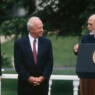 Three men on the lawn of the White House.