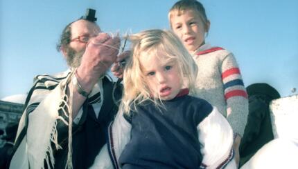 picture of a jewish boy having his hair cut for the first time