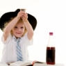 Photo of a young child holding up a kiddush cup.
