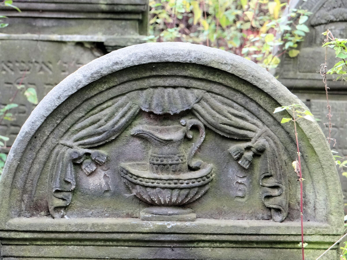 detail of a gravestone with a ewer