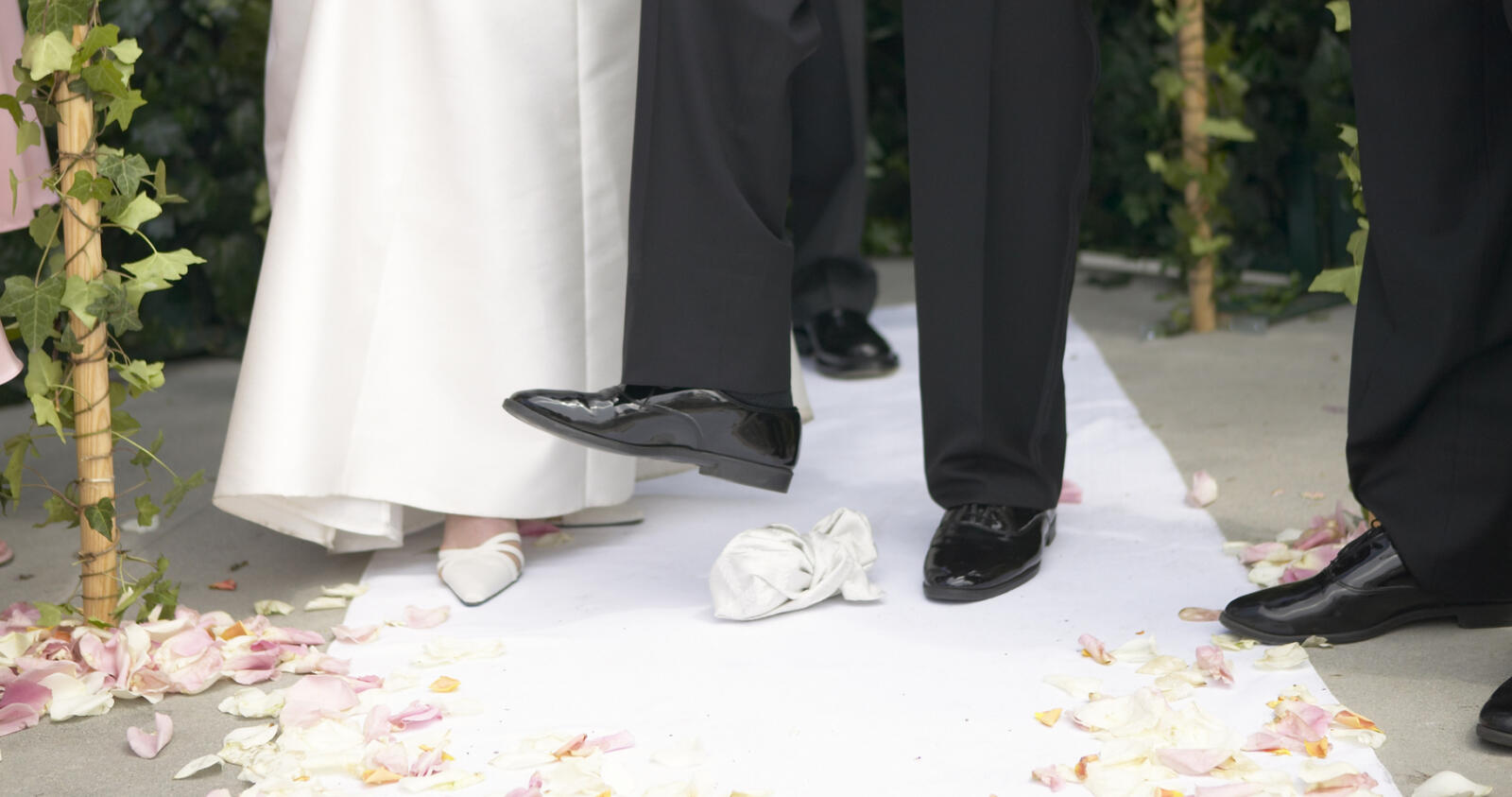 groom stomping on a glass at a jewish wedding