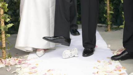 groom stomping on a glass at a jewish wedding