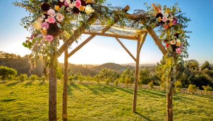 photo of a Jewish wedding canopy outdoors at sunset