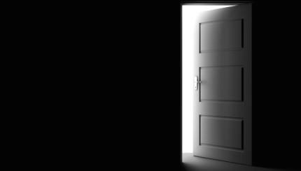 Open door in a dark room