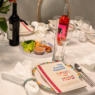 A traditional Passover seder table, featuring a Haggadah, a seder plate, wine and some of the foods enjoyed during the Jewish holiday of Passover