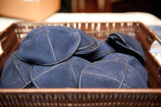 A basket of blue, custom stitched yarmulkes.