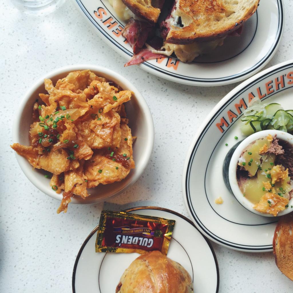 Gribenes, Pastrami and Potato Knish, Chopped Liver, and Rueben Sandwich. Photo by Aly Miller. 