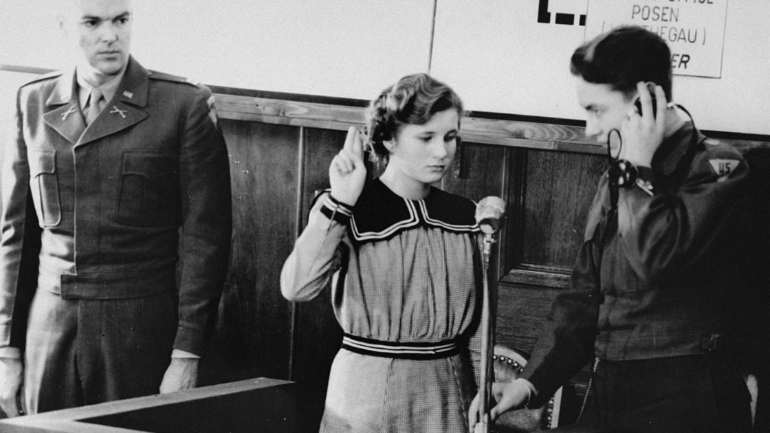 Maria Dolezalova, one of the children kidnapped by the Germans after they destroyed the Czech town of Lidice, is sworn in as a prosecution witness at the RuSHA Trial, Oct. 30, 1947. RuSHA was the Main Race and Resettlement Office, a central organization in the implementation of racial programs of the Third Reich. (United States Holocaust Memorial Museum, Courtesy of Hedwig Wachenheimer Epstein)