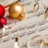 christmas ornaments lying on top of sheet music