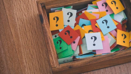 Question marks in a wooden box