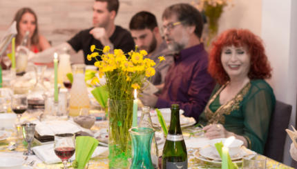 A family gathers during Passover for a traditional seder featuring matzah, wine and other Passover foods