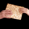 Handing a matzo from an old hand to a young hand.