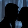 Boyfriend and girlfriend silhouettes kissing in dark, affection, love feeling