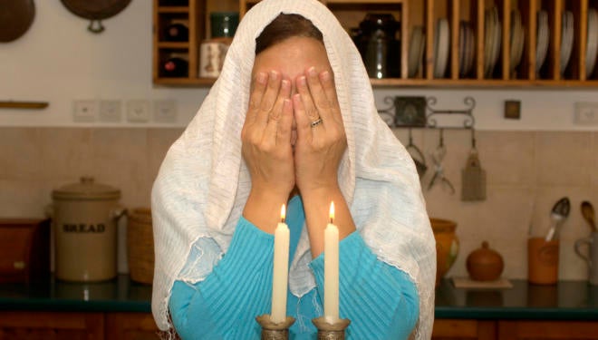 A Jewish woman blessing the Sabbath candles