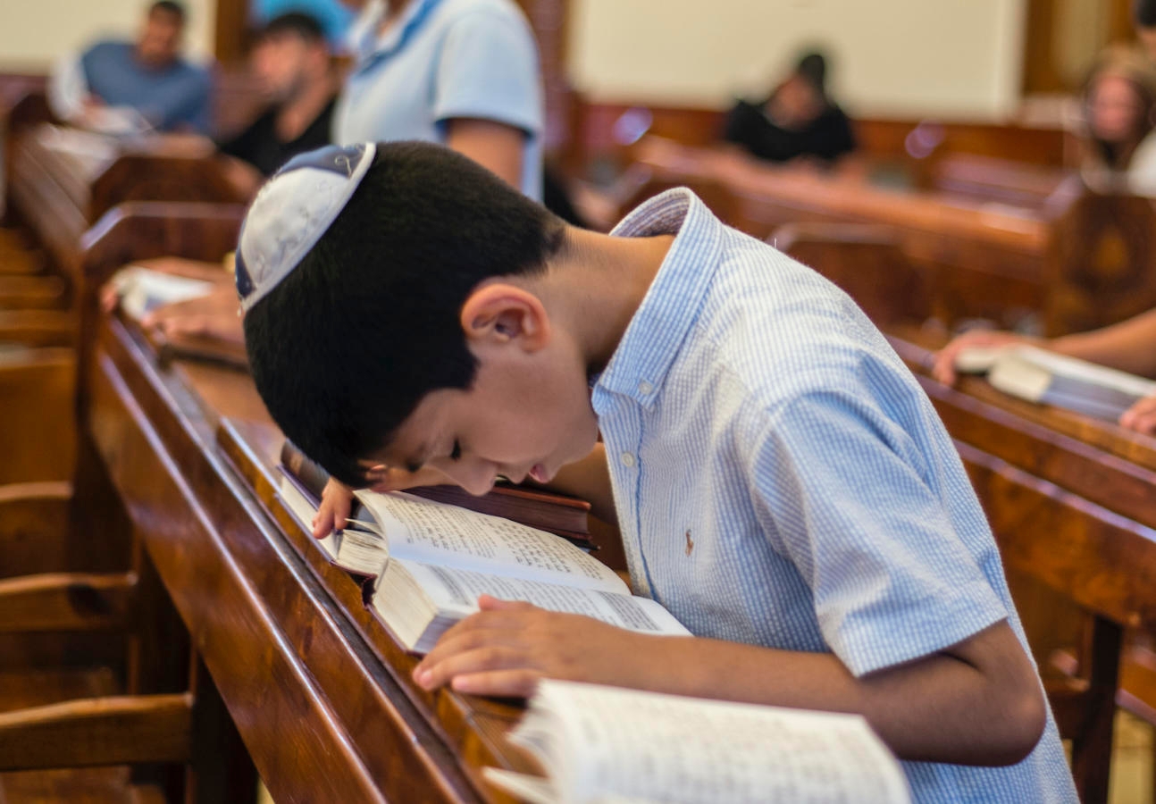 A boy bows for prayer during Mincha service in the Six-domed Synagogue in Qırmızı Qəsəbə, or Red Town, Quba district of Azerbaijan on 28 September 2016. Qırmızı Qəsəbə is a biggest compact settlement of the Mountain Jews in the world. The population of the Town is near 4 thousand people. Residents of the Red Town work and live mostly in Moscow. They build or renovate houses and residences and spend in the town summer vacations. People also use to come back to the Qırmızı Qəsəbə when one of the relatives die. They visit a Synagogue every day for special prayer. ( (Photo by Oleksandr Rupeta/NurPhoto))
