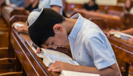 A boy bows for prayer during Mincha service in the Six-domed Synagogue in Qırmızı Qəsəbə, or Red Town, Quba district of Azerbaijan on 28 September 2016. Qırmızı Qəsəbə is a biggest compact settlement of the Mountain Jews in the world. The population of the Town is near 4 thousand people. Residents of the Red Town work and live mostly in Moscow. They build or renovate houses and residences and spend in the town summer vacations. People also use to come back to the Qırmızı Qəsəbə when one of the relatives die. They visit a Synagogue every day for special prayer. ( (Photo by Oleksandr Rupeta/NurPhoto))