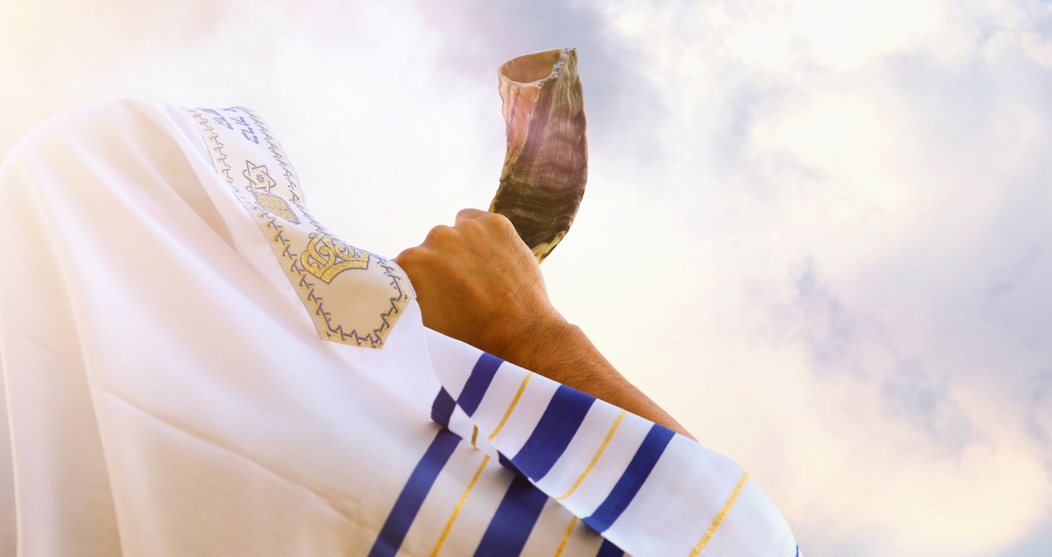 Jewish man blowing the Shofar (horn) of Rosh Hashanah (New Year). Religious symbol