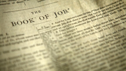 Bible open to the first page of the Book of Job.