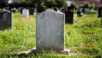 Blank gravestone with other graves in the background