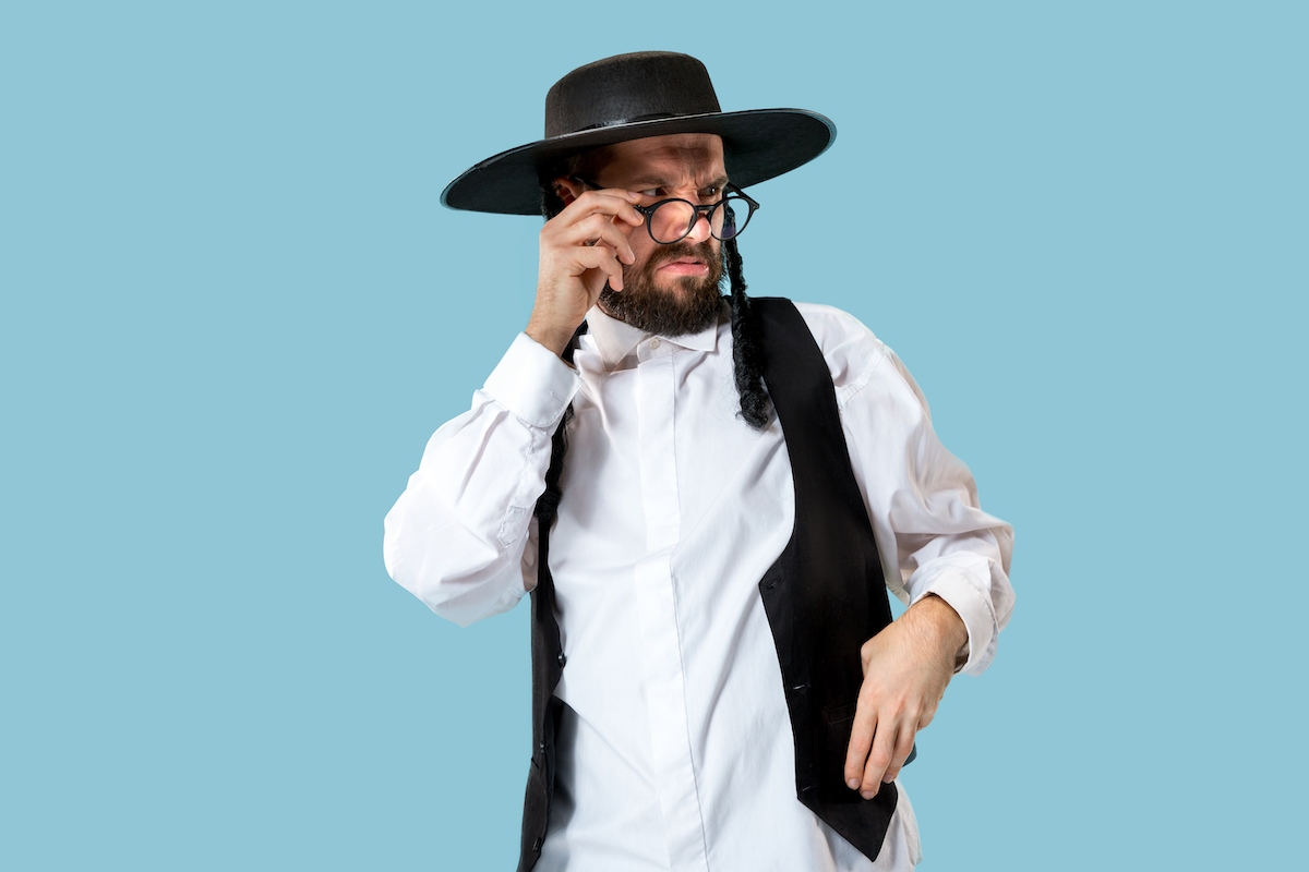 A Hasidic Jew squinting angrily over his glasses.