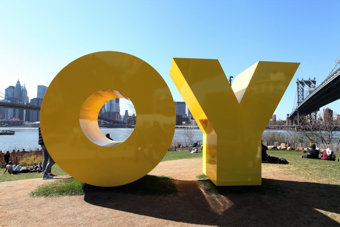 Large Yellow sculpture that is made of two yellow letters, O and Y.