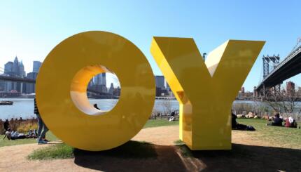 Large Yellow sculpture that is made of two yellow letters, O and Y.