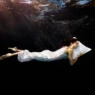 Woman with head on pillow sleeping underwater