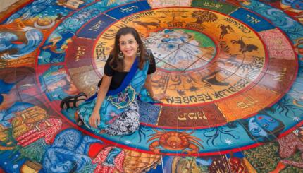 woman sitting on a colorful mosaic tile floor