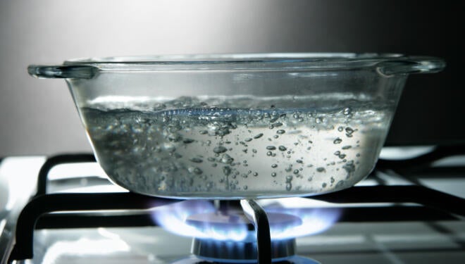 Glass saucepan on the gas stove close-up