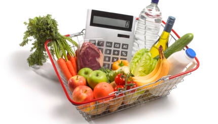 Basket with groceries and a calculator.