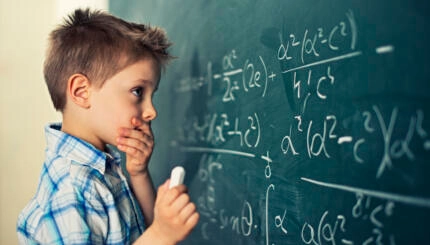 Little boy in math class overwhelmed by the math formula.