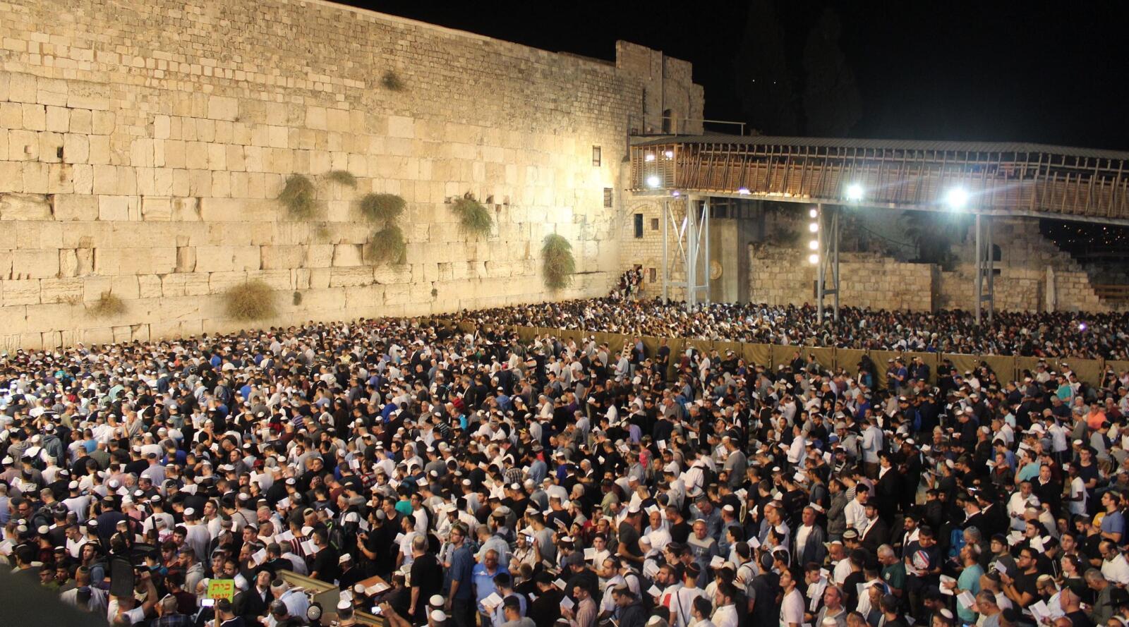 large crowd at the Western Wall at night