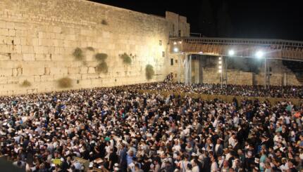 large crowd at the Western Wall at night