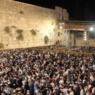 large crowd at the Western Wall at night