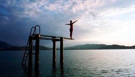 Woman on Diving Board in Lake