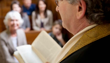 photo of a rabbi speaking to a congregation