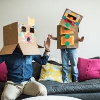 Father and daughter wearing robot costumes at home