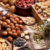 Assortment of nuts on rustic wood table.